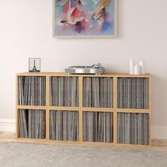 a white entertainment center with records on it