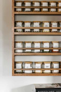 shelves filled with jars and spices on top of each other next to a bookshelf