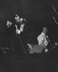 black and white photograph of two men on stage