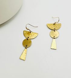 The Montclair earrings from our Boho Brass Geometric Collection features a hammered arch design.  Contrasting textures will be sure to catch the light as well as compliments.  Composed of raw brass which will naturally oxidize over time giving way to a beautiful patina.  Inspired by the rustic allure of California's north coast, this collection boasts a lovely earthy aesthetic.  Ear wires are 14kt Gold Filled Clover Gifts, Contrasting Textures, Earthy Aesthetic, Wedding Bridesmaid Jewelry, Arch Design, Egyptian Jewelry, Jewellery Inspiration, Gold Statement Earrings, North Coast