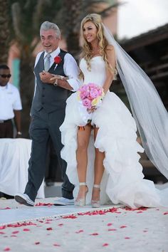 the bride and groom are walking down the aisle at their wedding ceremony on the beach