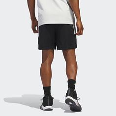 Cut to a mid-rise, these men's adidas basketball shorts are made from a breathable, soft, recycled fabric that goes beyond sport. They have an elastic-drawstring waist, side pockets, and three stripes. Wear them with a hoodie and sneakers for a casual look.Front Style: Flat FrontClosure Type: Drawstring, Full ElasticFit: Regular FitPockets: 2 Side Slip PocketsRise: Mid RiseShort Length: Mid LengthFiber Content: 100% Recycled PolyesterFabric Description: WovenInseam: 9 InCare: Machine Wash, Tumbl Adidas Sports Nylon Shorts, Adidas Nylon Sports Shorts, Adidas Sporty Nylon Shorts, Black Nylon Adidas Bottoms, Adidas Black Nylon Bottoms, Sporty Bottoms With Built-in Shorts For Basketball, Adidas Shorts For Workout During Sports Season, Sporty Adidas Athletic Shorts With Elastic Waistband, Adidas Athletic Shorts For Streetwear