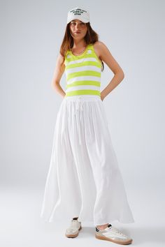 Add a touch of elegance to your wardrobe with our Maxi Skirt in White Fluid Fabric with Elastic Waist. Crafted from 100% viscose, this skirt offers a lightweight and breathable feel, making it perfect for warm weather. The skirt features a flowy A-line silhouette that falls gracefully to a maxi length, creating a beautiful and relaxed fit. The elastic waist ensures comfort and ease of wear, making it an ideal choice for daily wear. The versatile white color allows for easy pairing with various t Flowy Maxi Skirt, Simple Tank Tops, Verde Lima, Flowy Maxi Skirts, Boho Fabric, Skirt Jumpsuit, Wide Stripes, Spring Looks, Estilo Boho