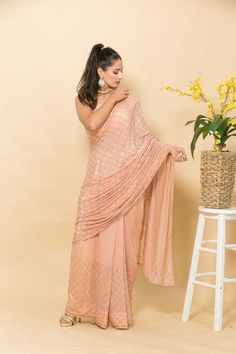 This peach crepe saree features intricate Mukaish embroidery and small pearl design for a stunning look perfect for parties and weddings. Its luxurious feel and gorgeous design make it a timeless piece that you'll never tire of wearing. Traditional Peach Pre-draped Saree With Zari Work, Peach Traditional Wear With Resham Embroidery For Reception, Elegant Peach Sharara With Traditional Drape, Elegant Peach Sharara With Mirror Work, Peach Pre-draped Traditional Saree, Unstitched Peach Sharara With Traditional Drape, Traditional Pre-draped Peach Saree With Zari Work, Peach Sharara With Traditional Drape For Reception, Floor-length Pre-draped Saree With Chikankari Embroidery For Reception