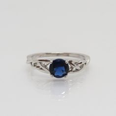 Celtic Sterling Silver Blue Sapphire Band Ring ...Marked 925...Total of weights 2.0grams...Size 8...Measure of stone 5.9MM...It's in very good condition. Adjustable Blue Sapphire Ring Fine Jewelry, Classic Blue Stone Rings, Classic Blue Round Stone Ring, Classic Blue Ring With Round Stone, Classic Blue Rings With Round Stone, Blue Oval Sterling Silver Birthstone Ring, Blue Oval Birthstone Ring In Sterling Silver, Adjustable Blue Sapphire Ring, Blue Sapphire Sterling Silver Promise Ring