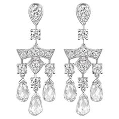 Experience the elegance of timeless design with these captivating earrings, a true testament to fine craftsmanship and luxury. The highlight of these earrings is the six briolette diamonds weighing a total of 3.46 carat, poised gracefully at the bottom. Above them assented with white round diamonds, altogether weighing 1.14 carats, catching the light from every angle and creating a mesmerizing sparkle. Complementing the design, 1.14 carats of white round diamonds are thoughtfully placed, enhancing the luminosity of the main stones and adding depth and allure. The entire piece is set in 18 karat white gold, amplifying the brilliance of the diamonds and bestowing a refined finish. 18 Karat White Gold Briolette Diamonds: 3.46 carat White Round Diamonds: 1.140 carat Luxury Briolette Earrings With Diamond Accents, Briolette Diamond, Diamond Dangle Earrings, Belle Epoque, Rose Cut Diamond, Rose Cut, Diamond White, Round Diamonds, Timeless Design