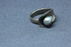 "Sterling Silver Gray Pearl Ring. Vintage Modernist sterling silver and gray pearl ring. Ring is fully hallmarked and will arrive gift boxed. * HALLMARKS Sterling and makers mark which I couldn't make out. * WEIGHT 7.91 Grams * Size 6 1/2, ring can be resized by any good jeweler. Face of ring measures 1/2\" at widest part. * CONDITION In very good condition. Please use pictures as part of item's description. * MATERIALS Sterling Silver, gray pearl" Handmade Silver Pearl Ring For Formal Occasions, Modern Silver Pearl Ring As Gift, Modern Silver Pearl Ring For Gifting, Pearl Ring Vintage, Mens Initial Ring, Pearl Jewelry Ring, Ancient Coin Jewelry, Fine Pearl Jewelry, Healing Crystal Ring