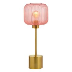 a pink glass lamp on a gold base