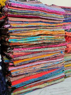 a large stack of colorful fabrics sitting next to each other