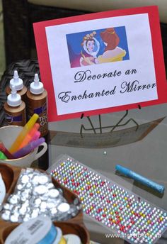 there is a sign that says decorate an enchanted mirror on the glass table