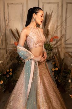 Casablanca features a pale pink raw silk skirt and halter neck top paired with a powder blue tulle dupatta.by Chamee and Palak. DELIVERY TIMEPlease allow 4-6 months for your outfit to arrive. FABRIC DETAILSRaw silk, Net. Professional cleaning only. Ruched Skirt Outfit, Blue Bridal Lehenga, Lengha Blouse Designs, Lehenga Top, Raw Silk Lehenga, Wedding Lehenga Designs, Blue Tulle, Indian Bridal Outfits, Blue Bridal