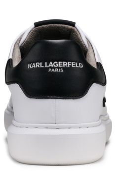 An Iconic Karl Lagerfeld image details the sides of these crisp white sneakers for casual days. Round toe Lace-up vamp Padded collar White sole Leather and synthetic upper, synthetic sole Imported Casual Lace-up Sneakers With Logo, Classic High-top Sneakers With Logo, Trendy Sports Sneakers With Logo, Trendy Streetwear Sneakers With Embossed Logo, Classic High-top Sneakers With Logo For Streetwear, Trendy White High-top Synthetic Sneakers, Casual White High-top Synthetic Sneakers, Trendy White Sneakers With Vulcanized Sole, Casual White High-top Sneakers With Logo