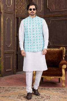 Look your best at any festive occasion with this stunning pain white jacket style men's kurta with churidar. Made from cotton art silk fabric, that adds to its traditional appeal. The Chinese collar and full sleeves offer a stylish touch, while the bottom made of art silk fabric completes the look. The jacket is adorned with intricate resham thread, sequins, and printed work. Designed to fit a wide range of body types, this jacket style men's kurta with churidar can be customized up to a maximum size of 46 inches. Plain Kurta, Silk Pant, Men's Kurta, Chinese Collar, Printed Jacket, Nehru Jacket, Nehru Jackets, Festive Wear, Silk Pants