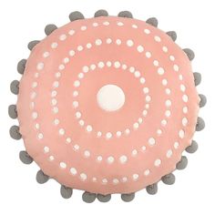 a pink and grey pom pom cushion with white polka dots on the bottom