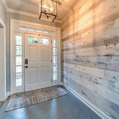 a white front door with a light hanging above it