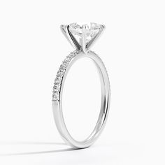 a white gold engagement ring with a princess cut diamond in the center and side stones