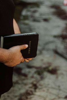 a person holding a bible in their hand