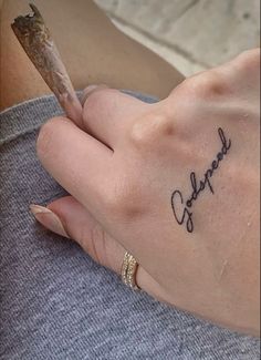 a woman's hand with a small tattoo on her left wrist and the word charlotte written in cursive writing