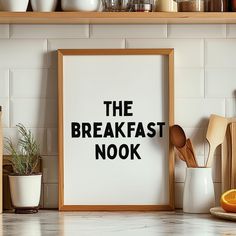 the breakfast nook sign is displayed in front of some kitchen utensils