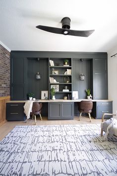 a living room filled with furniture and a ceiling fan