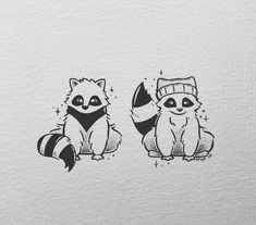 two raccoons with hats on their heads sitting next to each other