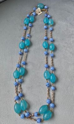 Rare Murano glass 1950s beaded necklace with original tag still on. Beautiful colour combination of aqua/green and light blue where 1" oval beads alternate with smaller round beads and polished metal chain. Original screw closure. Length: 26" or cm 66 closed, 52" or cm 132 open. Ideal gift for a lady who appreciates rare and fine things or....for yourself! Vintage Czech Glass Oval Beaded Necklace, Blue Oval Beads Single Strand, Elegant Light Blue Jewelry With Large Beads, Blue Single Strand Oval Beads, Blue Oval Single Strand Beads, Vintage Oval Beaded Necklaces For Jewelry Making, Blue Single Strand Necklace With Oval Beads, Elegant Light Blue Necklace With Beaded Chain, Elegant Light Blue Beaded Chain Necklaces