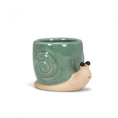 a ceramic cup with a snail on it