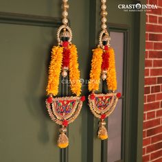 two pairs of earrings hanging from a door