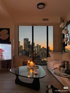 a living room filled with furniture and a flat screen tv mounted to the wall next to a window