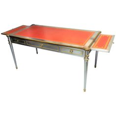 V-60 desk by John Vesey. A rare example of this very elusive desk. Solid stainless steel body with bronze doré mounts, hardware by P.E. Guerin and original gold embossed red leather top. The desk has three drawers lined in suede, including one with a combination lock as well as two pull-out writing rests on the sides. Dummy drawers on other side with same hardware. Each writing rest is 10.25" deep including the pull. Pictures #7 and 18" are closer to actual color of leather. Gold Chinoiserie Wallpaper, Steel Desk, Desk Styling, Gold Writing, Desk Writing, Chinoiserie Wallpaper, Leather Desk, Writing Table, Brushed Steel