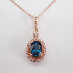 Rose Gold Diamond and London Blue Topaz Pendant Necklace Chain.  Diamond Specifications: Shape: Round Brilliant Amount: 36 Diamonds Color: H (colorless) Clarity: I1 (eye clean) Carat Weight: .20 carat Gemstone Specifications: Type: Natural London Blue Topaz  Shape: Oval Color: Blue Measurement: 8 X 6 mm Gem Weight: 1 1/2 carats Metal Specifications: Type: 10K Rose Gold Weight: 2.5 grams  Measurement: 20 X 10 mm with the bail Chain: 18" 10K Rose Gold Additional Information: Authenticity Certified Formal Blue Topaz Oval Pendant Necklace, Elegant Oval Topaz Necklace, Oval Topaz Necklace For Formal Occasions, Formal Oval Topaz Necklace, Wedding Topaz Gemstone Accent Necklaces, Wedding Topaz Necklace With Gemstone Accents, Formal Rose Gold Sapphire Jewelry, Elegant Oval Pendant Topaz Necklace, Elegant Topaz Oval Pendant Necklace