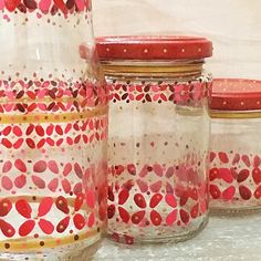 four glass jars with hearts painted on them