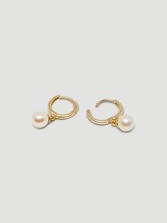 DESCRIPTIONObsessed is the first word that comes to mind when we see these! As an important part of our Pearl Collection, these earrings pay homage to a timeless and classic adornment, the pearl. These sweet 10mm huggies are crafted in 14k yellow gold and have a small cultured, freshwater pearl dangling below, making a current trend timeless. These simple statement earrings pair well with literally anything else in the collection but we love them specifically paired with The Pearl and Chain Drop Chain Drop Earrings, Pearl Collection, The Pearl, Pearl Studs, Gold Hoop, Statement Earrings, Freshwater Pearls, Gold Bracelet, Yellow Gold