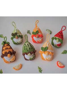 small crocheted fruits and vegetables are displayed on a table