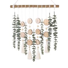 a wooden and metal wind chime with leaves on it