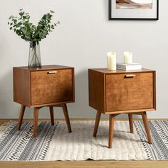 two wooden nightstands sitting on top of a rug in front of a white wall