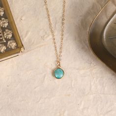 "Turquoise pendant necklace for her. Compressed turquoise dainty round bezel gold necklace. 14k gold filled chain. Turquoise jewelry for her. Pendant: 8mm x 8mm Material: Compressed Turquoise (see below) Chain: 14k gold filled Clasp: Spring ring Chain: 16 inches Made in the USA Arrives in giftbox Note: *5th photo is to show other necklaces in this Turquoise collection. They are all sold separately. This listing if for the round bezel pendant only. What is compressed turquoise? Compressed Turquoi Gold Gemstone Necklace, Gold Necklace Simple, Turquoise Pendant Necklace, Necklace For Her, Coin Pendant Necklace, Ring Chain, Dainty Pendant, Bezel Pendant, Jewelry For Her