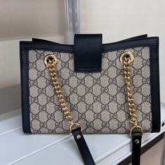 For a stylish, classy and luxurious look, this Gucci bag is the perfect choice. Sling this beauty on your shoulders and revel in the luxurious taste it brings. Gucci Monogram, Monogrammed Leather, Timeless Handbag, Gucci Black, Diaper Backpack, Vuitton Bag, Chain Shoulder Bag, Bags Designer Fashion, Leather Chain