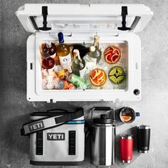 an open yeti cooler sitting on top of a table filled with drinks and beverages