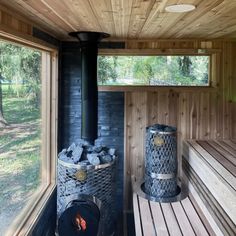 the inside of a wooden sauna with logs in it