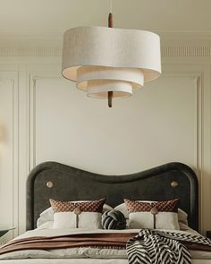 a bedroom with a large bed and two lamps hanging from the ceiling