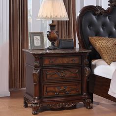 a bedroom scene with focus on the night stand and bed in the foreground,