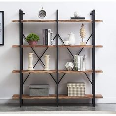 a book shelf with books, vases and other items on it in a living room