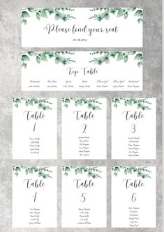 wedding seating cards with greenery on them