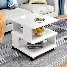 a white coffee table sitting on top of a rug in a living room next to a couch