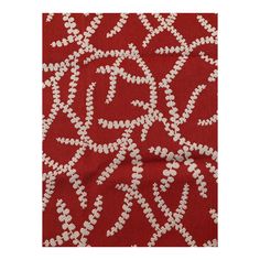 a red and white fabric with small flowers on the side, in an intricate pattern