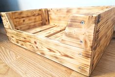 a wooden crate sitting on top of a hard wood floor