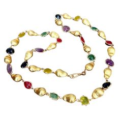 Diana's Necklace is a masterpiece crafted for those who desire rarity and elegance. This exquisite 40-inch long necklace is adorned with a captivating selection of gemstones, including amethyst, green fluorite, blue crystal, red jade, and lemon jade, each adding a unique touch of color and brilliance. Complemented by gold-plated brushed beads, this necklace not only stands out as a rare and precious find but also enhances any outfit with its vibrant array of colors. The versatile and colorful ge Colorful Gemstones, Red Jade, Green Fluorite, August Birthstone Jewelry, July Birthstone Jewelry, Jewelry Ring Box, Pearl Jewellery Earrings, Men's Jewelry Rings, Evil Eye Jewelry