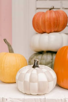 pumpkins and gourds are sitting on a table