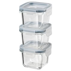 three glass containers stacked on top of each other with lids for food and water in them